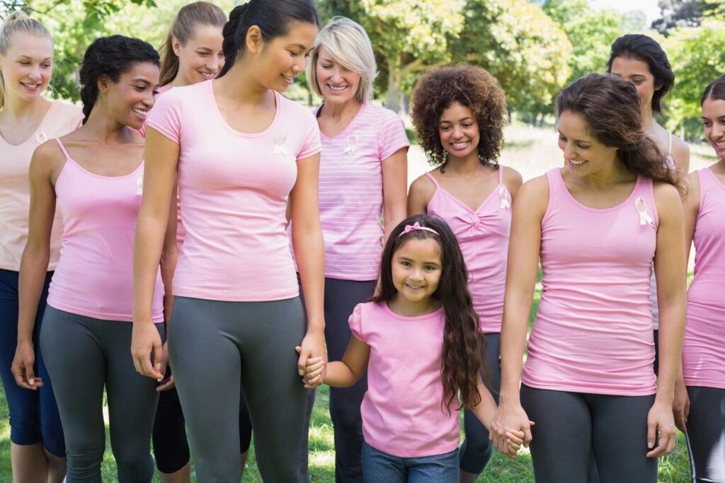 group of women wearing pink shirts in support of cancer research
